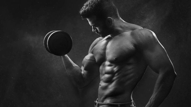 Bench press bar path for beginners: J-curve touching lower chest and pressing back toward shoulders, reducing shoulder stress